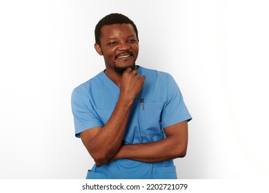 Smiling Black Surgeon Doctor Bearded Man In Blue Coat With Isolated On White Background. Happy Adult Black African American Practicing Surgeon Portrait, Confident Look