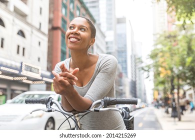 Smiling Black Woman With Bike In The City - Beautiful Happy Woman In Chicago Leaning On Her Bicycle And Relaxing During A Commute