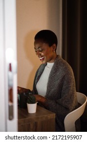 Smiling Black Woman Working Late From Home