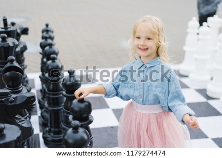 Similar – lifestyle shot of smart kid girl playing checkers at home