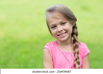 Smiling Blond Girl With Braid. Girl Seven Years.