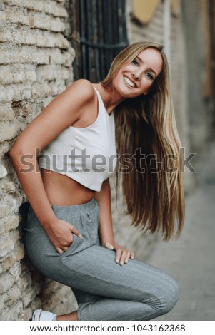 Similar – Happy young woman with moving hair in urban background