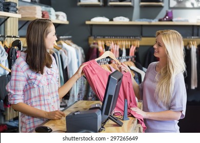 Smiling blonde doing shopping in clothes store