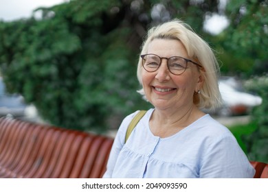 Smiling Blonde Teacher Woman Lady 40s 50s Years Old Wearing Eyeglasses Standing Hold Notepads Looking Camera Outdoors