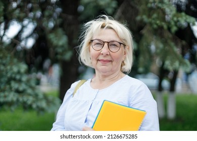 Smiling Blonde Teacher Woman Lady 40s 50s Years Old Wearing Eyeglasses Standing Hold Notepads Outdoors