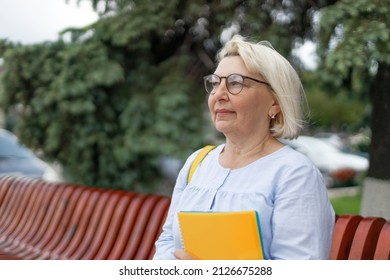 Smiling Blonde Teacher Woman Lady 40s 50s Years Old Wearing Eyeglasses Standing Hold Notepads Looking Camera Outdoors