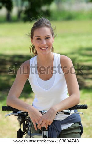 Smiling blonde woman on a bicycle