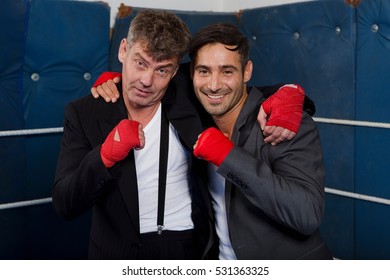 Smiling boxers hugging in ring