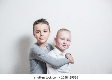 smiling boy and a 7 year old girl looking at the camera