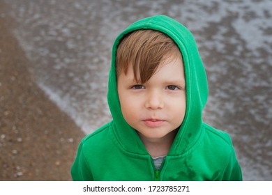 Smiling Boy In A Green Jacket