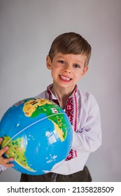 Smiling Boy Holding Globe In Hands