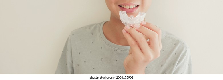 Smiling Boy Holding Invisalign Braces, Mouthguard, Teen Orthodontic Oral Health Care Concept