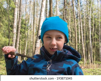 Smiling Boy With A Knife On Forest Background