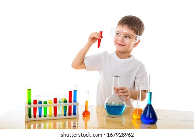 Smiling boy making chemical experiment, isolated on white