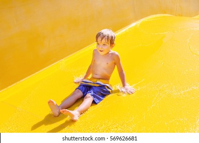 Smiling Boy On A Waterslide