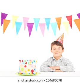 Smiling Boy With Party Hat And A Birthday Cake Isolated Against White Background