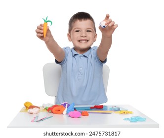 Smiling boy showing carrot and ball made from play dough on white background - Powered by Shutterstock