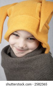 smiling boy in yellow hat