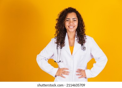 Smiling Brazilian doctor woman in a white coat.