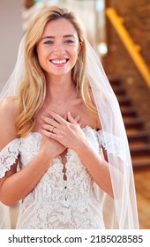 Smiling Bride In Bridal Store Trying On Wedding Dress