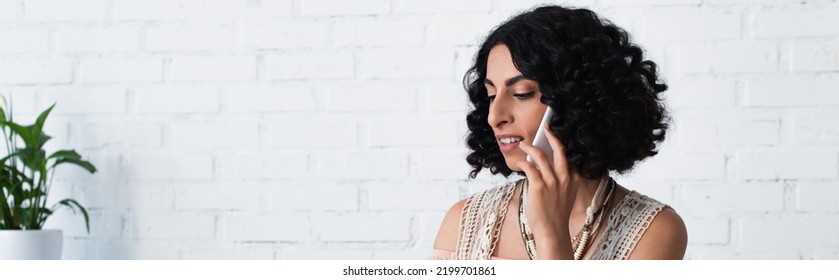 Smiling Brunette Fortune Teller Talking On Mobile Phone At Home, Banner