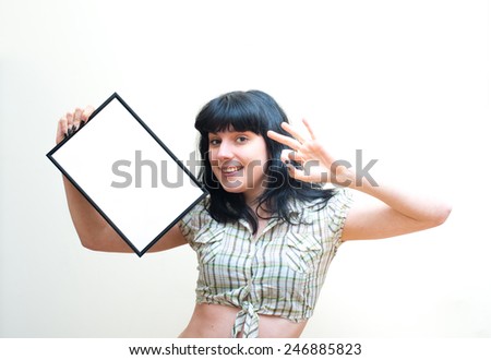 Smiling brunette girl pin up look showing blank frame on white background