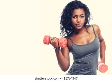 Smiling Brunette Woman In Grey Sportswear Sits On Fitness Ball And Holds Small Dumbells.