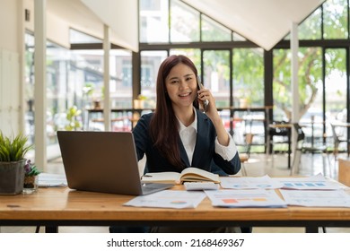 Smiling Business Asian Woman In Black Suit Talking On Phone