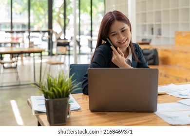 Smiling Business Asian Woman In Black Suit Talking On Phone