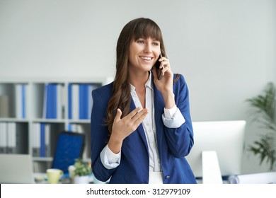 Smiling Business Lady Talking On The Phone In Office