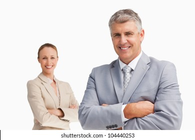 Smiling Business People With Folded Arms Against White Background