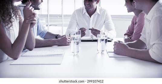 Smiling Business People In Meeting At Conference Table In Office