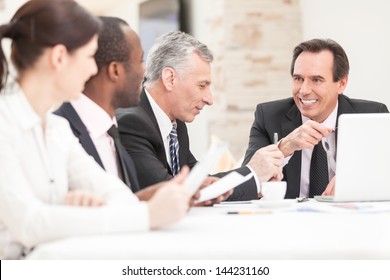 Smiling Business People With Paper Work In Board Room - Staff Meeting