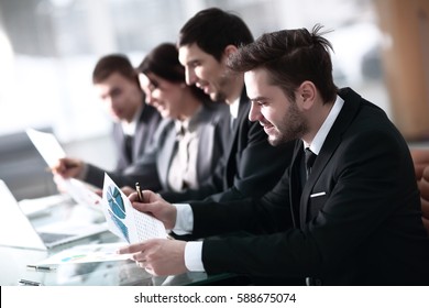 Smiling business people with paper work in board room