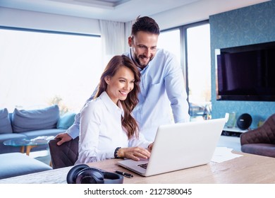 Smiling Business People Using Laptop While Working Together On New Project. 