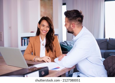 Smiling Business People Using Laptop While Working Together On New Project. 