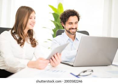 Smiling Business People At Work In Their Office. Shallow Depth Of Field, Focus On The Man