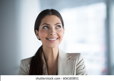 Smiling Business Woman Looking up at Copy Space - Powered by Shutterstock