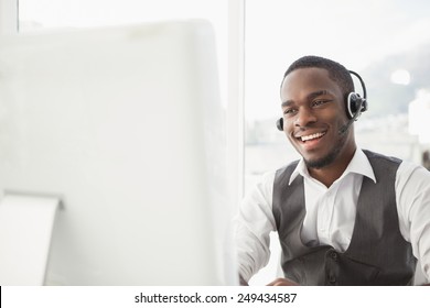 Smiling businessman with headset interacting in his office - Powered by Shutterstock