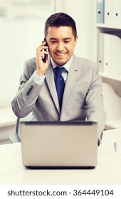 Smiling Businessman With Laptop And Smartphone