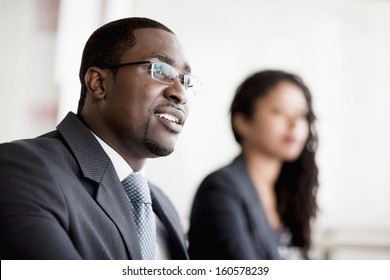 Smiling Businessman Listening At Business Meeting