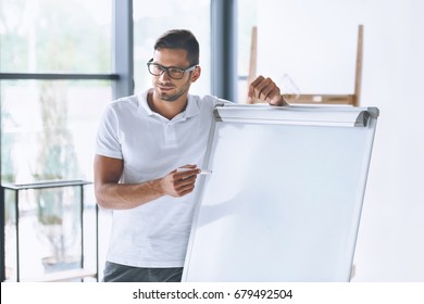 Smiling Businessman Making Presentation At White Board In Office