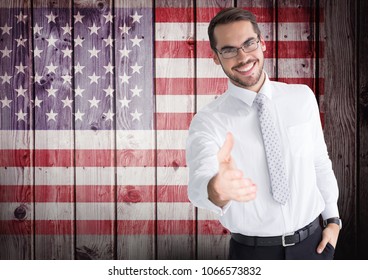 Smiling businessman offering his hand for independence day - Powered by Shutterstock