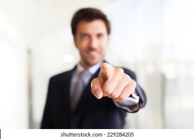 Smiling Businessman Pointing His Finger At You