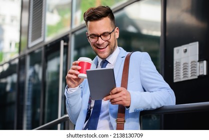 Smiling Businessman Searching Internet With Tablet And Enjoying In Coffee Break In Front Of The The Office. Business, Lifestyle Concept