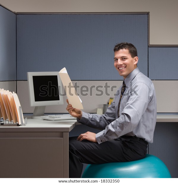 Smiling Businessman Sitting On Exercise Ball Stock Photo Edit Now