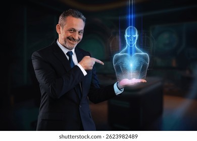 Smiling businessman in suit pointing at a glowing digital hologram of a human figure in a high-tech virtual environment. Concept of innovation, AI and future technology.