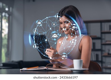 Smiling businesswoman in casual wear holding tablet device touching it at office workplace. Concept of distant work, business education, information technology. Social network abstract hologram - Powered by Shutterstock