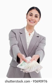 Smiling Businesswoman Handing Over Money Against A White Background