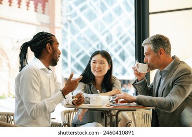 Smiling businesswoman having a cup of coffee with a collegue. - Powered by Shutterstock